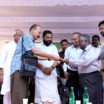 Dr. Vijayaraghavan receiving the beneficiary cheque